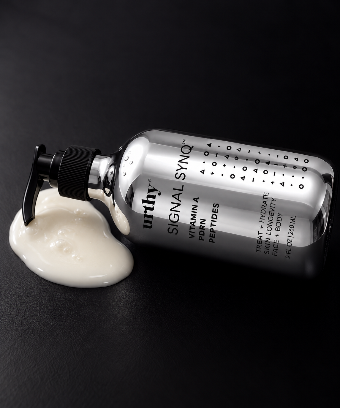 Signal Synq 9 fl oz bottle on its side with white lotion, black background