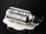 Signal Synq 9 fl oz bottle lying in a pool of white lotion